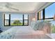 Bedroom with waterfront view, ceiling fan, and lots of natural light at 8779 Midnight Pass Rd # 406H, Sarasota, FL 34242
