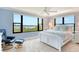 This primary bedroom with water views features a large window and neutral decor at 8779 Midnight Pass Rd # 406H, Sarasota, FL 34242