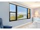 A gorgeous view of the water outside a large window in this comfortably furnished bedroom at 8779 Midnight Pass Rd # 406H, Sarasota, FL 34242