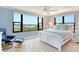 Bedroom with waterfront views, bright neutral paint, ceiling fan and comfortable chair at 8779 Midnight Pass Rd # 406H, Sarasota, FL 34242
