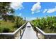 A wooden boardwalk leads from the condos to the beach at 8779 Midnight Pass Rd # 406H, Sarasota, FL 34242