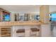 Kitchen breakfast bar with built-in wine fridge at 8779 Midnight Pass Rd # 406H, Sarasota, FL 34242