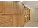 This large walk-in closet features custom wood shelving, cabinets and drawers, providing ample storage space at 8779 Midnight Pass Rd # 406H, Sarasota, FL 34242