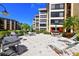 Exterior view of the common area with tables, chairs, lounge chairs, and grills at the condo complex at 8779 Midnight Pass Rd # 406H, Sarasota, FL 34242
