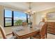 Dining room with carved chairs, wood table, and bay view at 8779 Midnight Pass Rd # 406H, Sarasota, FL 34242