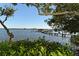 Scenic dock view surrounded by lush greenery, perfect for enjoying waterfront activities at 8779 Midnight Pass Rd # 406H, Sarasota, FL 34242