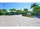 Community entrance featuring lush tropical landscaping and decorative brick pavers at Island Reef at 8779 Midnight Pass Rd # 406H, Sarasota, FL 34242