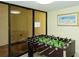 Game room with foosball table and sliding glass doors at 8779 Midnight Pass Rd # 406H, Sarasota, FL 34242