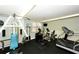 Community gym with exercise equipment, including a treadmill, elliptical, and weight machine at 8779 Midnight Pass Rd # 406H, Sarasota, FL 34242