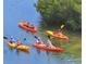Group kayaking in calm waters showcasing the property's recreational water access at 8779 Midnight Pass Rd # 406H, Sarasota, FL 34242