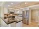 Kitchen with granite countertops and stainless refrigerator at 8779 Midnight Pass Rd # 406H, Sarasota, FL 34242