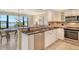 Kitchen with granite breakfast bar with view of dining room at 8779 Midnight Pass Rd # 406H, Sarasota, FL 34242