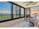 Enjoy great views from this amazing lanai featuring a glass table and two comfortable chairs at 8779 Midnight Pass Rd # 406H, Sarasota, FL 34242