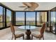 Enjoy great views from this amazing lanai featuring a glass table and two comfortable chairs at 8779 Midnight Pass Rd # 406H, Sarasota, FL 34242