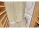 Well-organized laundry area with shelving, washer, dryer, and closet for storage at 8779 Midnight Pass Rd # 406H, Sarasota, FL 34242