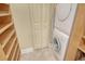 This laundry room features a stackable washer and dryer with custom built in shelving at 8779 Midnight Pass Rd # 406H, Sarasota, FL 34242