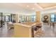 Open-concept living room with breakfast bar and expansive water views from large windows at 8779 Midnight Pass Rd # 406H, Sarasota, FL 34242