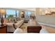 Living room with a glimpse into the kitchen and dining areas, featuring tile flooring at 8779 Midnight Pass Rd # 406H, Sarasota, FL 34242