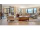 Bright living room with tile flooring, neutral furnishings, and stunning water views at 8779 Midnight Pass Rd # 406H, Sarasota, FL 34242