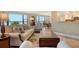 Comfortable living room featuring neutral tones, tile flooring, and a beautiful ocean view at 8779 Midnight Pass Rd # 406H, Sarasota, FL 34242