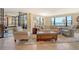 Bright living room with comfortable seating, tile floors, and expansive windows offering a water view at 8779 Midnight Pass Rd # 406H, Sarasota, FL 34242