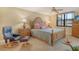 Cozy main bedroom featuring a ceiling fan, comfortable chair, and side tables with lamps at 8779 Midnight Pass Rd # 406H, Sarasota, FL 34242