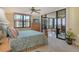 Comfortable main bedroom features a ceiling fan and sliding glass doors leading to the lanai at 8779 Midnight Pass Rd # 406H, Sarasota, FL 34242