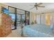 Spacious main bedroom with ceiling fan, dresser, and sliding glass doors to the lanai at 8779 Midnight Pass Rd # 406H, Sarasota, FL 34242