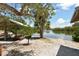 Scenic picnic area featuring a grill and a view of a serene waterway under a partially cloudy sky at 8779 Midnight Pass Rd # 406H, Sarasota, FL 34242