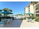 A community space features patio seating by the pool with views of the beach at 8779 Midnight Pass Rd # 406H, Sarasota, FL 34242