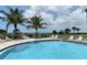 A curved pool offers walk-in access and views of the beach at 8779 Midnight Pass Rd # 406H, Sarasota, FL 34242