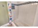 Clean shower stall with tiled walls and a decorative mosaic tile border, adjacent to curtain at 8779 Midnight Pass Rd # 406H, Sarasota, FL 34242
