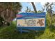 Turtle Beach sign surrounded by lush tropical landscaping at 8779 Midnight Pass Rd # 406H, Sarasota, FL 34242