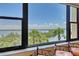 Picturesque water view with palm trees seen from a window at 8779 Midnight Pass Rd # 406H, Sarasota, FL 34242