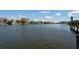 A serene waterfront view of waterfront condos, showcasing clear water and blue skies on a beautiful day at 8779 Midnight Pass Rd # 406H, Sarasota, FL 34242