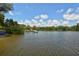 Expansive waterfront featuring docks and lush green surroundings under a partly cloudy sky, perfect for water activities at 8779 Midnight Pass Rd # 406H, Sarasota, FL 34242