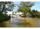 Scenic waterfront showing a kayak launch site by a parking area surrounded by lush greenery under a clear sky at 8779 Midnight Pass Rd # 406H, Sarasota, FL 34242
