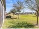 Lush backyard featuring a well-maintained lawn and tranquil green space in a peaceful community at 9743 Pembrooke Pines Dr, Sun City Center, FL 33573