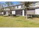 Well-maintained backyard featuring a screened patio and manicured lawn, ideal for outdoor enjoyment and entertaining guests at 9743 Pembrooke Pines Dr, Sun City Center, FL 33573
