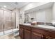 Bathroom featuring a double sink vanity with granite countertop, tiled shower and toilet at 9743 Pembrooke Pines Dr, Sun City Center, FL 33573