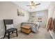 Neutral bedroom with double bed, chair, ceiling fan and decor at 9743 Pembrooke Pines Dr, Sun City Center, FL 33573
