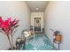 Inviting entryway featuring a decorative rug, chair, and plants, enhancing the home's curb appeal at 9743 Pembrooke Pines Dr, Sun City Center, FL 33573