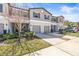 Charming two-story townhome with a well-manicured front yard and attached garage, offering a welcoming curb appeal at 9743 Pembrooke Pines Dr, Sun City Center, FL 33573