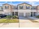 Charming townhome with a well-manicured lawn and gray shutters at 9743 Pembrooke Pines Dr, Sun City Center, FL 33573