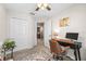 Bright office space with a desk, brown chair, large closet, and neutral decor, creating a comfortable work environment at 9743 Pembrooke Pines Dr, Sun City Center, FL 33573