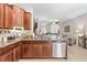 Open kitchen with stainless steel appliances and a breakfast bar at 9743 Pembrooke Pines Dr, Sun City Center, FL 33573