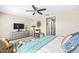 Comfortable main bedroom with light colored walls, ceiling fan, sitting area, and carpeted floors at 9743 Pembrooke Pines Dr, Sun City Center, FL 33573