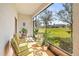 Relaxing screened-in patio with seating and a serene view of the community's green space at 9743 Pembrooke Pines Dr, Sun City Center, FL 33573