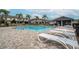 Community pool area featuring lounge chairs, paved patio, and nearby residential buildings at 9743 Pembrooke Pines Dr, Sun City Center, FL 33573