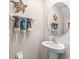 Stylish powder room with a modern vessel sink, decorative mirror, and charming decor at 9743 Pembrooke Pines Dr, Sun City Center, FL 33573